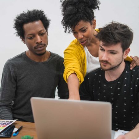 group-multiethnic-creative-business-people-working-project-business-woman-pointing-monitor-screen-showing-something-her-colleagues-business-concept